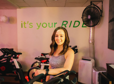 MINT Cycle instructor standing in the cycle studio
